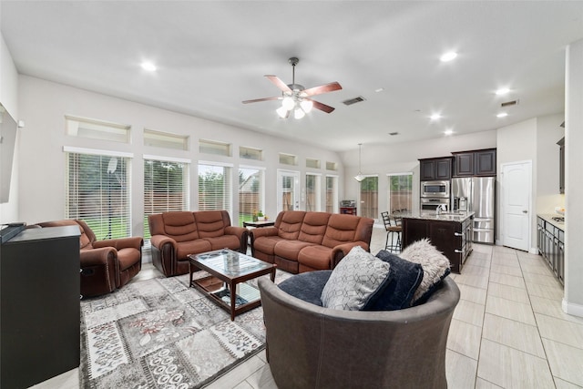 11143 Dunstan Hill Dr, Richmond, TX 77407 - living room featuring a ceiling fan, healthy amount of natural light, recessed lighting, and light tile patterned flooring