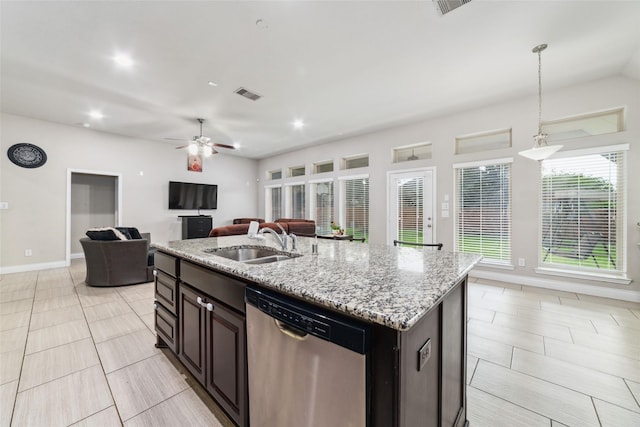 11143 Dunstan Hill Dr, Richmond, TX 77407 - kitchen with stainless steel dishwasher, a sink, open floor plan, light stone counters, and decorative light fixtures
