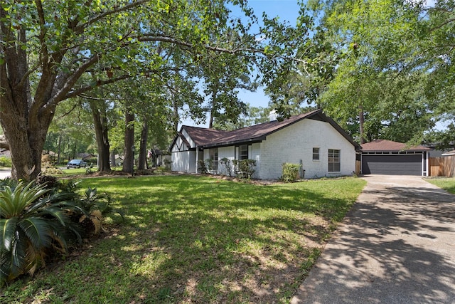 view of side of property with a yard and driveway