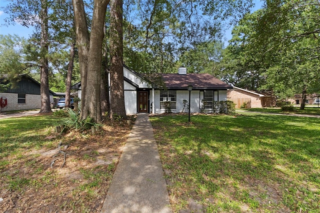 view of front of home with a front lawn and a chimney