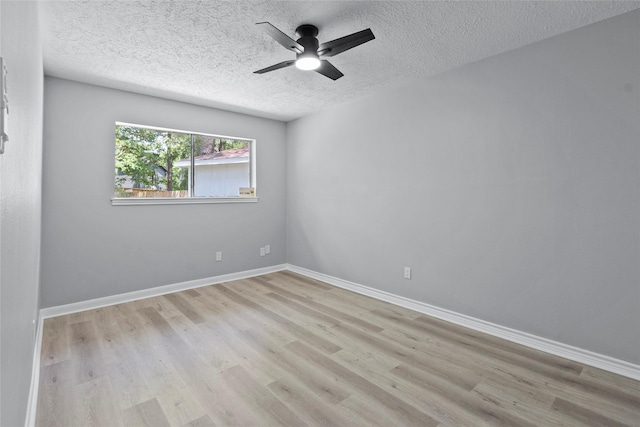 unfurnished room with baseboards, a textured ceiling, ceiling fan, and wood finished floors