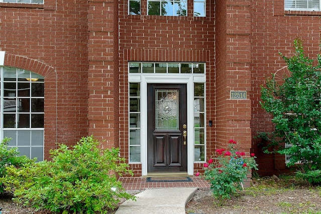 property entrance with brick siding