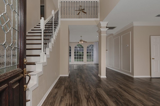 entrance foyer with stairs, ornate columns, ceiling fan, and baseboards