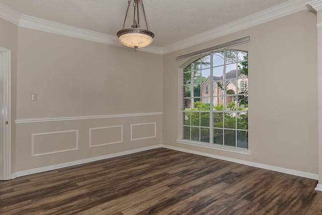 unfurnished room featuring crown molding, dark wood finished floors, and baseboards
