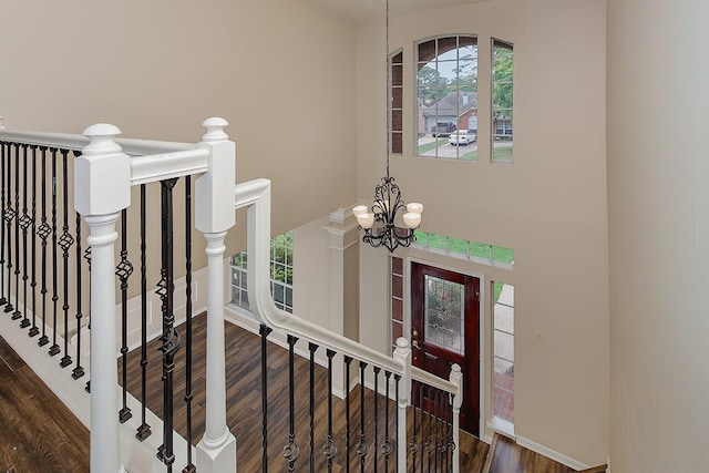 interior space featuring an inviting chandelier, baseboards, and wood finished floors