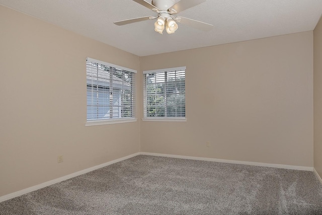 unfurnished room featuring carpet floors, baseboards, and ceiling fan