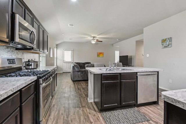 6011 Diantha St, Katy, TX 77449 - kitchen with appliances with stainless steel finishes, a sink, light wood-style floors, ceiling fan, and lofted ceiling