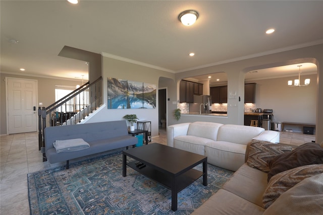 living area featuring an inviting chandelier, arched walkways, ornamental molding, and recessed lighting