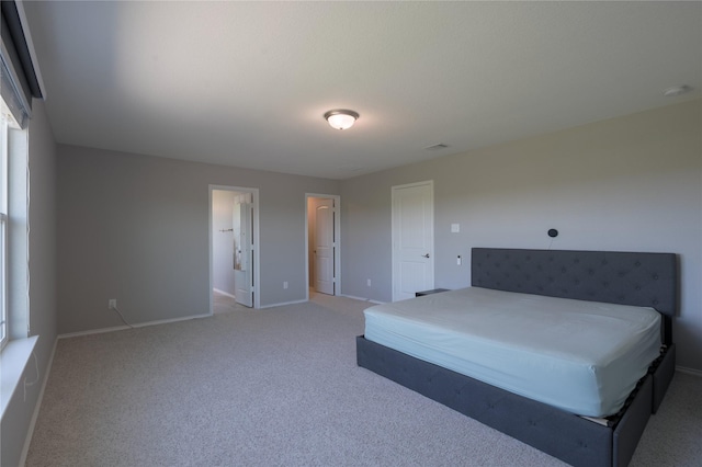 unfurnished bedroom with baseboards and light colored carpet