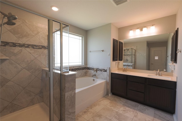 bathroom with double vanity, a sink, a bath, and a stall shower