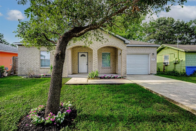 7315 Palestine St, Houston, TX 77020 - view of front of property with a garage, driveway, a front yard, and brick siding