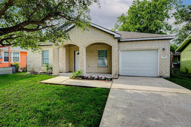 7315 Palestine St, Houston, TX 77020 - view of front of house featuring concrete driveway, a front yard, an attached garage, and brick siding