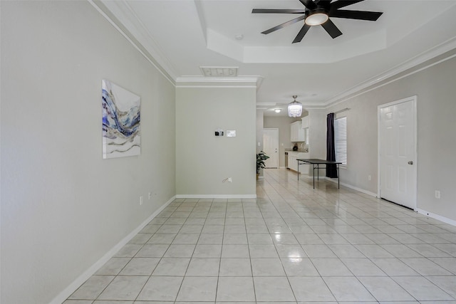 7315 Palestine St, Houston, TX 77020 - spare room featuring a tray ceiling, ceiling fan, crown molding, light tile patterned flooring, and baseboards