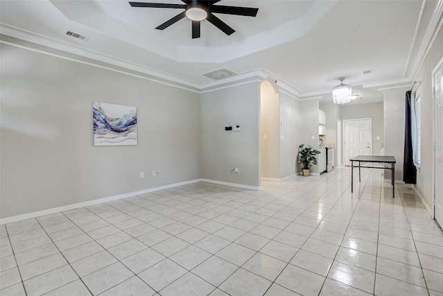 7315 Palestine St, Houston, TX 77020 - empty room with a tray ceiling, light tile patterned floors, ceiling fan, crown molding, and baseboards