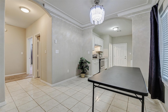 7315 Palestine St, Houston, TX 77020 - interior space with light tile patterned floors, arched walkways, a chandelier, crown molding, and baseboards