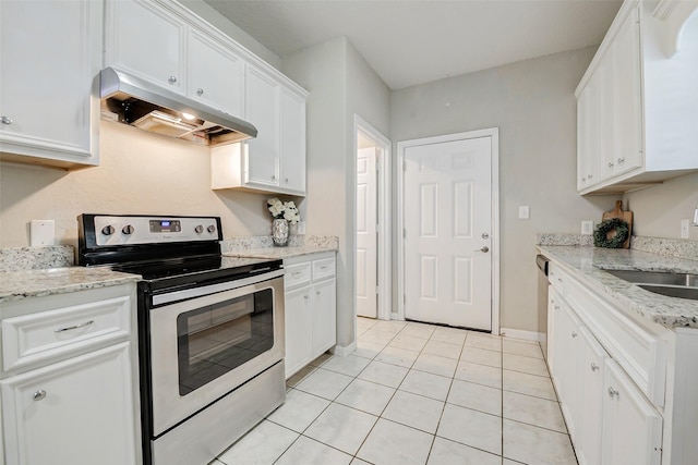 7315 Palestine St, Houston, TX 77020 - kitchen with appliances with stainless steel finishes, under cabinet range hood, white cabinetry, a sink, and light tile patterned floors