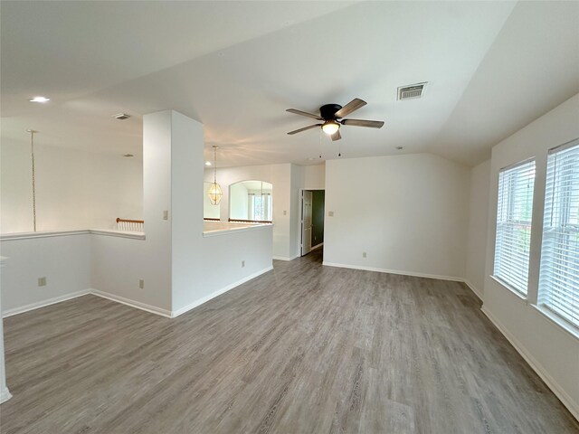 5310 Flagridge Ln, Houston, TX 77066 - unfurnished room featuring wood finished floors, ceiling fan, vaulted ceiling, and baseboards