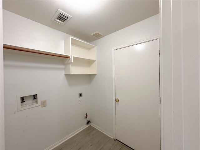 5310 Flagridge Ln, Houston, TX 77066 - laundry area with hookup for a gas dryer, washer hookup, light wood-style flooring, hookup for an electric dryer, and baseboards