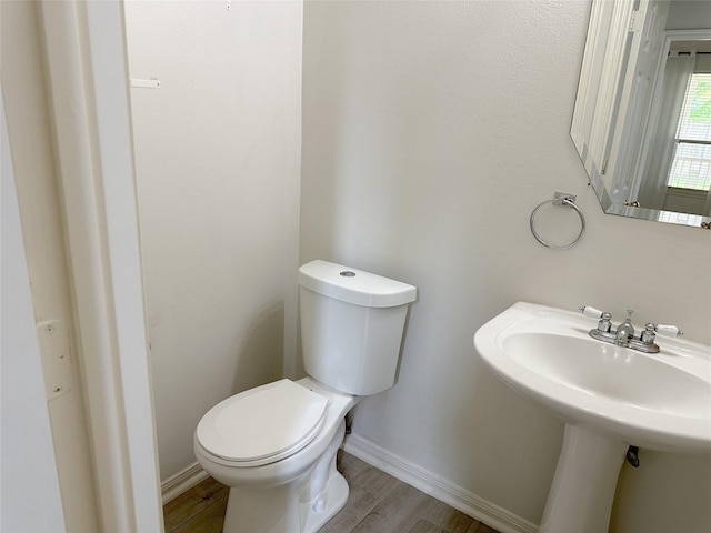 5310 Flagridge Ln, Houston, TX 77066 - half bathroom featuring wood finished floors, toilet, baseboards, and a sink