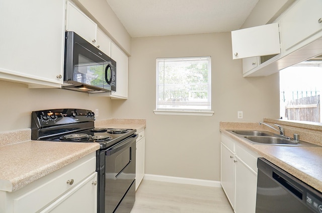 1950 Spenwick Dr Unit 302, Houston, TX 77055 - kitchen featuring a sink, white cabinets, black appliances, and light wood-style flooring
