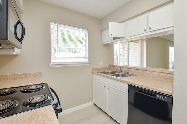 1950 Spenwick Dr Unit 302, Houston, TX 77055 - kitchen with a sink, white cabinets, black appliances, and light countertops