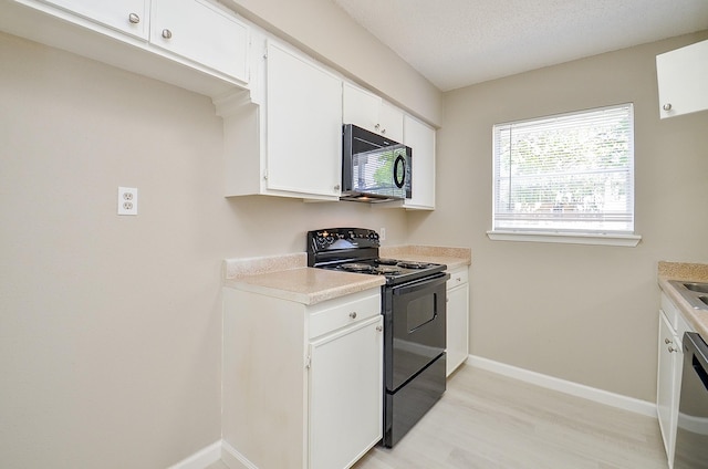 1950 Spenwick Dr Unit 302, Houston, TX 77055 - kitchen with baseboards, light wood-style floors, light countertops, white cabinets, and black appliances