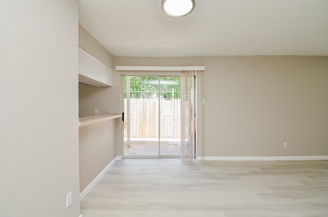 1950 Spenwick Dr Unit 302, Houston, TX 77055 - unfurnished room with baseboards and light wood-style flooring