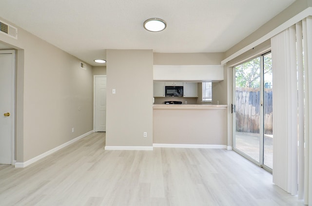 1950 Spenwick Dr Unit 302, Houston, TX 77055 - unfurnished living room featuring light wood-style floors, baseboards, and visible vents