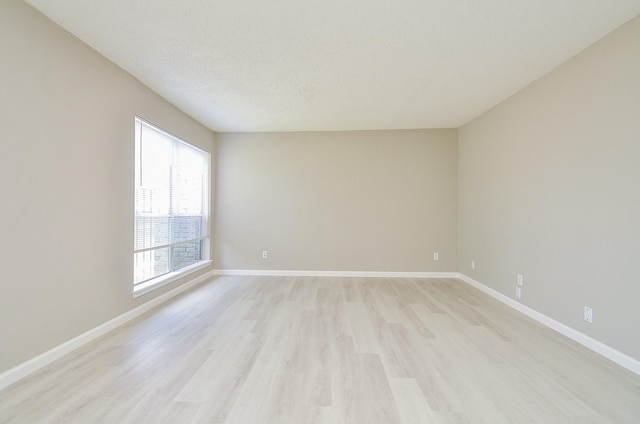 1950 Spenwick Dr Unit 302, Houston, TX 77055 - spare room with light wood-style floors, baseboards, and a textured ceiling