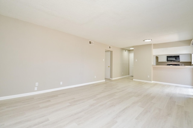 1950 Spenwick Dr Unit 302, Houston, TX 77055 - unfurnished living room featuring light wood-style floors, baseboards, and visible vents