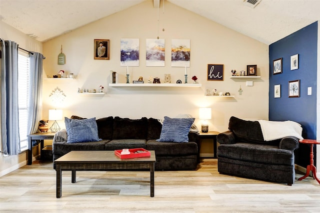 living room with wood finished floors and vaulted ceiling