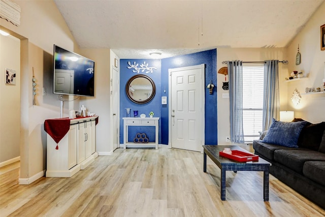 living room with baseboards and light wood-style flooring