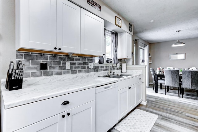 kitchen with a sink, white cabinetry, and dishwasher