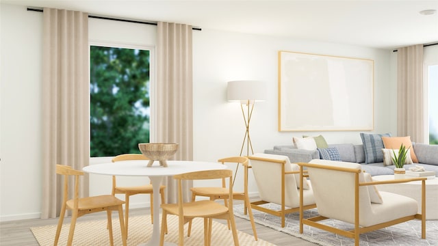 sitting room with baseboards and light wood-type flooring