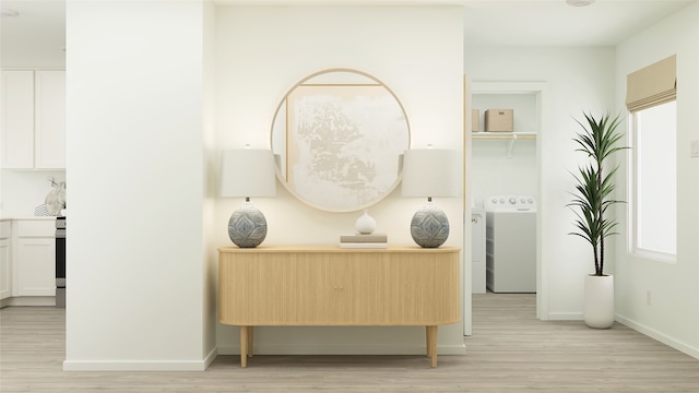 interior space with washer / dryer, baseboards, and light wood finished floors