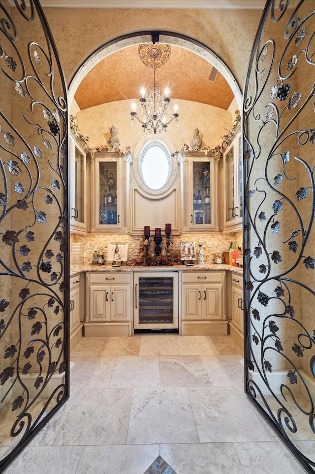 25 Kings Lake Estates Blvd, Humble, TX 77346 - bar featuring a notable chandelier, beverage cooler, arched walkways, indoor wet bar, and decorative backsplash