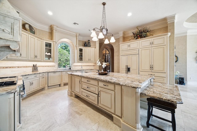 25 Kings Lake Estates Blvd, Humble, TX 77346 - kitchen featuring cream cabinets, crown molding, a center island with sink, and gas stove