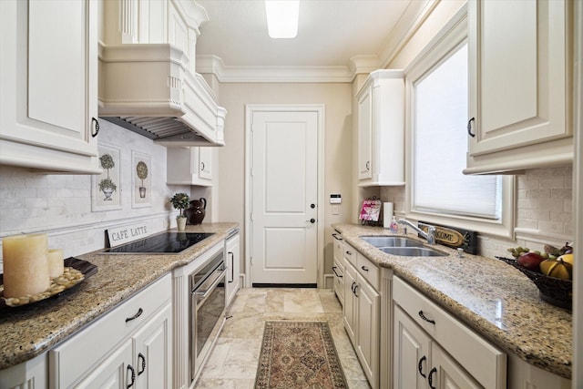 25 Kings Lake Estates Blvd, Humble, TX 77346 - kitchen with crown molding, oven, premium range hood, black electric cooktop, and a sink