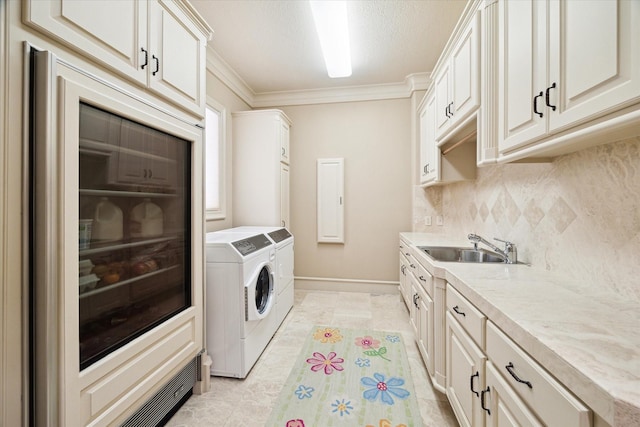 25 Kings Lake Estates Blvd, Humble, TX 77346 - laundry room with washer and dryer, crown molding, cabinet space, a sink, and baseboards
