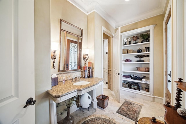 25 Kings Lake Estates Blvd, Humble, TX 77346 - bathroom featuring a sink, built in features, and ornamental molding