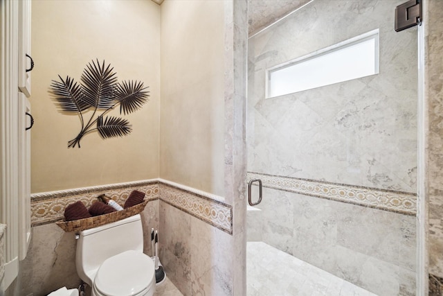 25 Kings Lake Estates Blvd, Humble, TX 77346 - bathroom with wainscoting, tile walls, a shower stall, and toilet