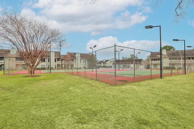 14777 Wunderlich Dr Unit 1103, Houston, TX 77069 - view of tennis court featuring fence, a lawn, and a residential view