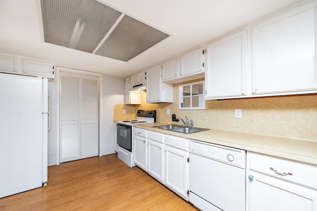 14777 Wunderlich Dr Unit 1103, Houston, TX 77069 - kitchen featuring a sink, light wood finished floors, under cabinet range hood, white appliances, and white cabinetry