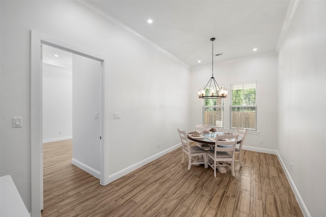 58-D Hickory Ridge Dr, Huffman, TX 77336 - dining area with light wood-style floors, ornamental molding, baseboards, and an inviting chandelier