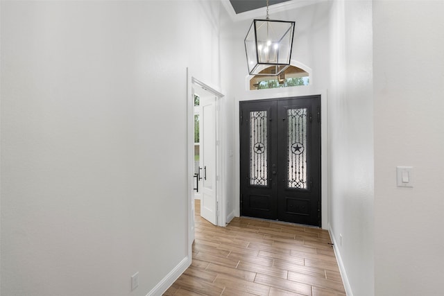 58-D Hickory Ridge Dr, Huffman, TX 77336 - foyer entrance featuring baseboards, light wood-style flooring, a notable chandelier, and french doors