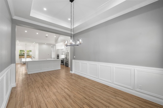 58-D Hickory Ridge Dr, Huffman, TX 77336 - interior space featuring crown molding, an inviting chandelier, a sink, a decorative wall, and a wainscoted wall