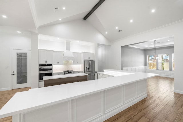 58-D Hickory Ridge Dr, Huffman, TX 77336 - kitchen featuring recessed lighting, appliances with stainless steel finishes, premium range hood, and a spacious island