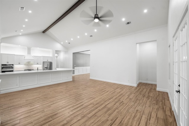 58-D Hickory Ridge Dr, Huffman, TX 77336 - unfurnished living room with beamed ceiling, visible vents, ceiling fan, and light wood-type flooring