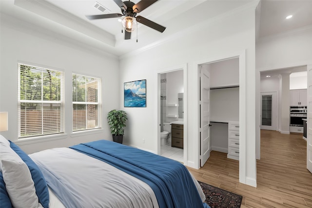 58-D Hickory Ridge Dr, Huffman, TX 77336 - bedroom with visible vents, ornamental molding, light wood-style floors, and baseboards