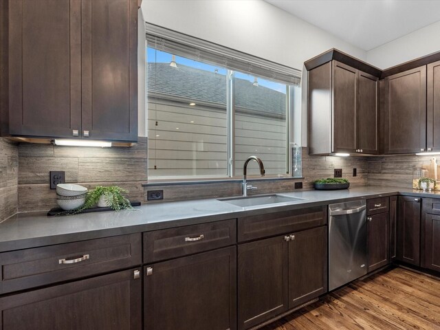 302 Eado Park Cir, Houston, TX 77020 - kitchen featuring dark brown cabinetry, tasteful backsplash, dishwasher, a sink, and light wood finished floors